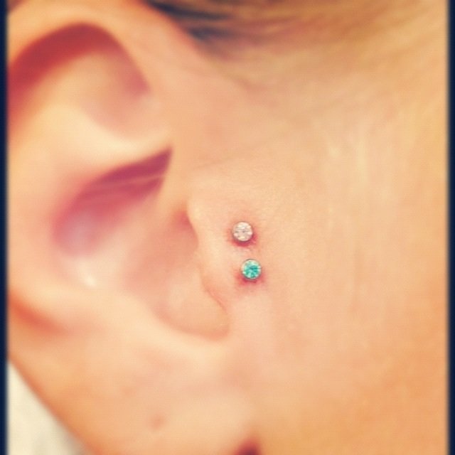 Double Tragus Piercing With Silver And Blue Anchor