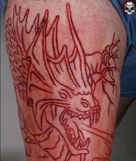 Dragon Scarification Tattoo On Right Thigh