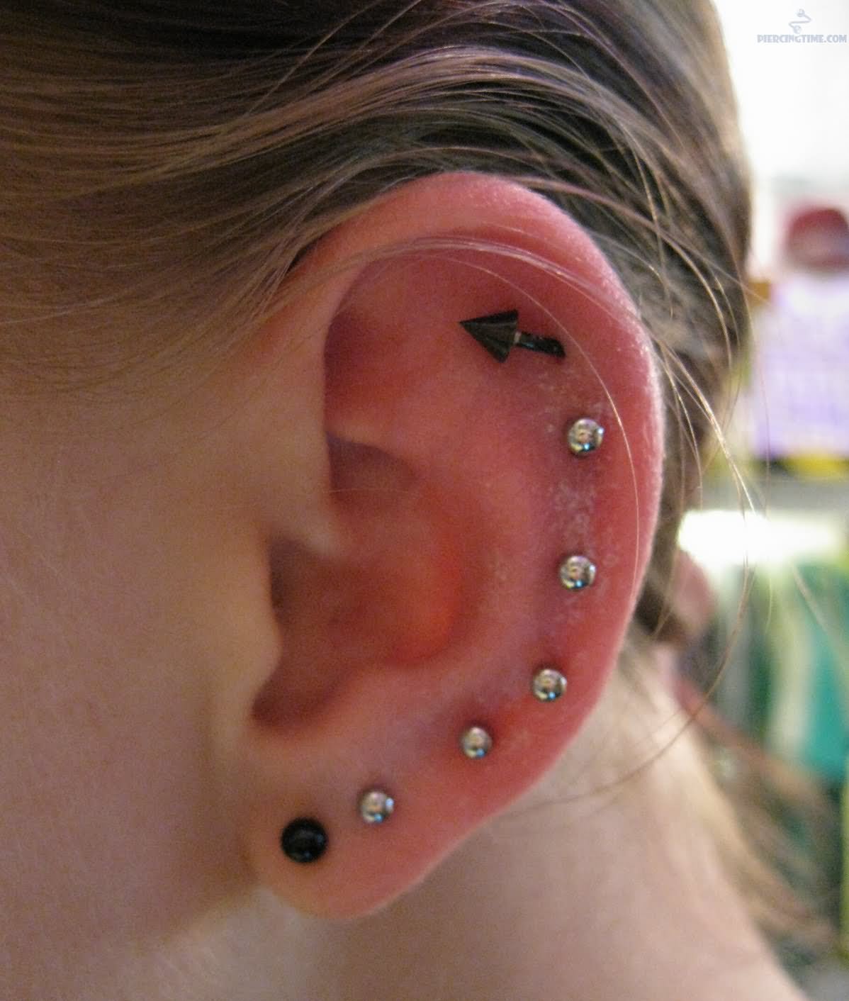 Ear Project Piercing With Silver And Black Studs