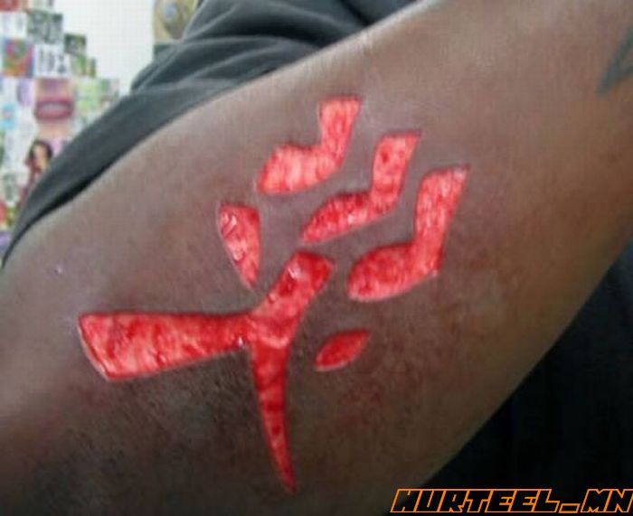Extreme Scarification Tattoo On Arm Sleeve