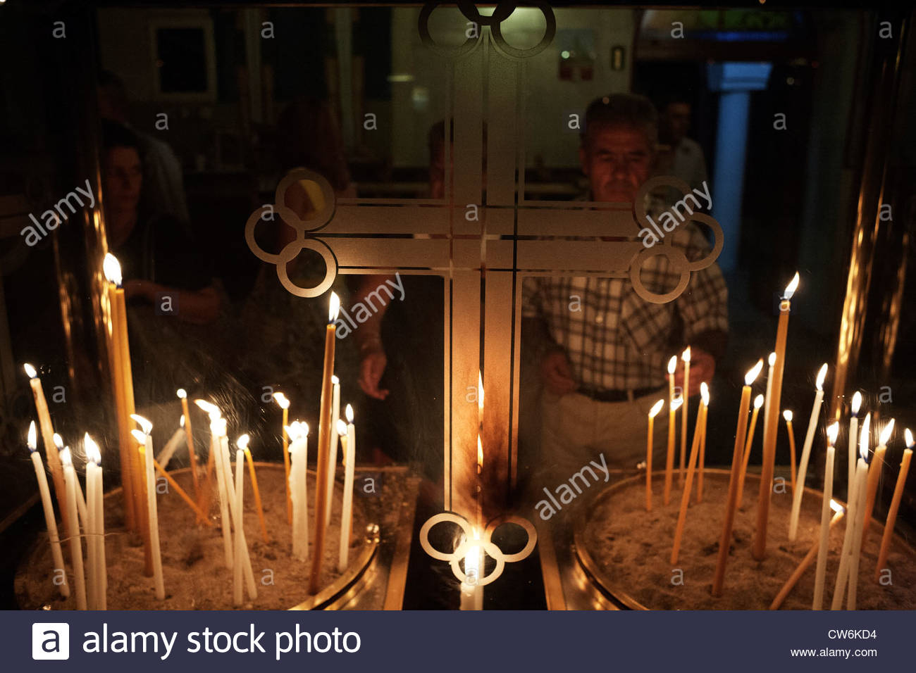 Family Lights Candles In The Church During The Celebration Of Feast Of Assumption Of Mary