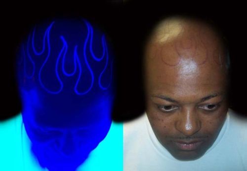 Flaming Head In Daylight And UV Light Tattoo For Men