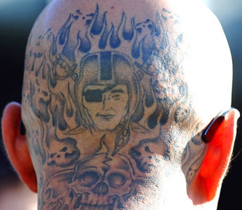 Flaming Oakland Raiders And Skulls Back Head Tattoo