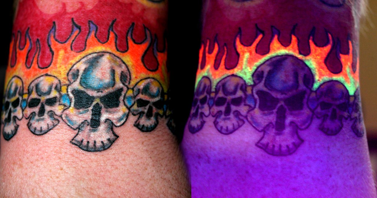 Flaming Skulls In Daylight And UV Light Tattoo