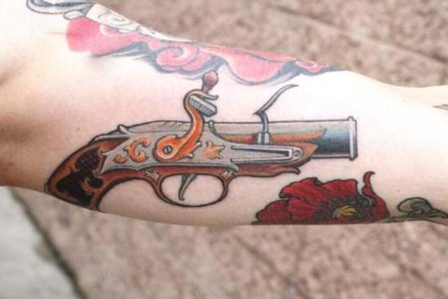Flintlock Pistol Weapons Tattoo On Biceps