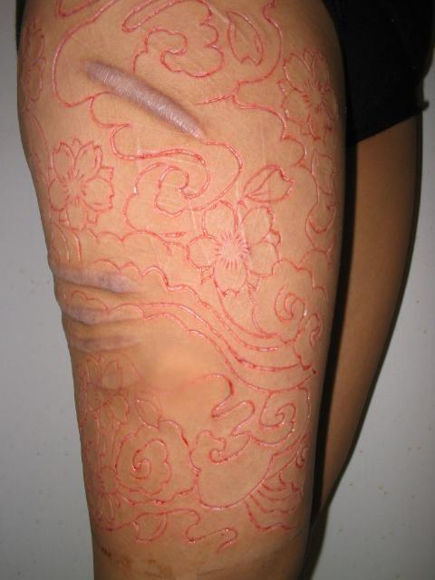 Flowers Scarification Tattoo On Thigh