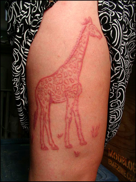 Giraffe Scarification Tattoo On Thigh