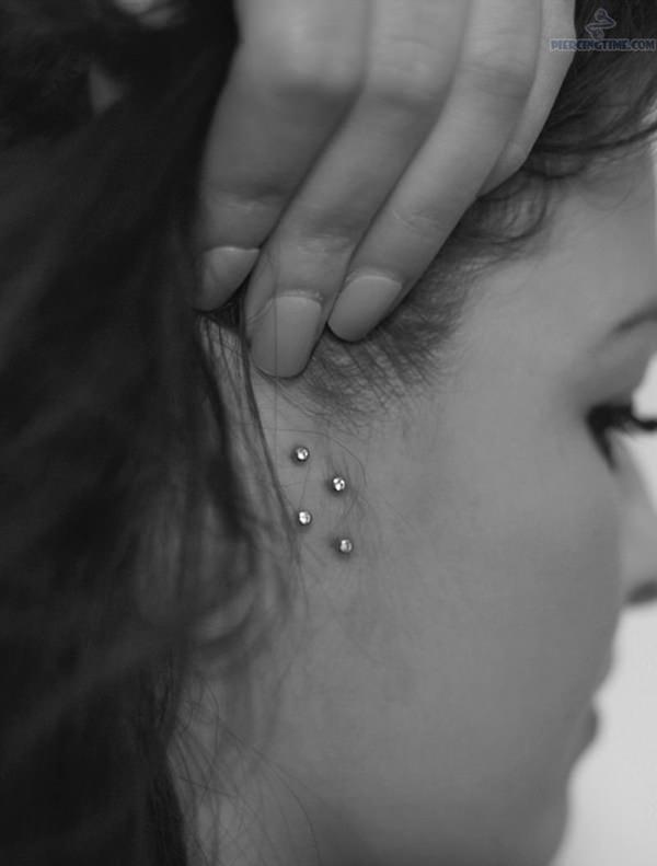 Girl Showing Her Surface Double Tragus Piercing