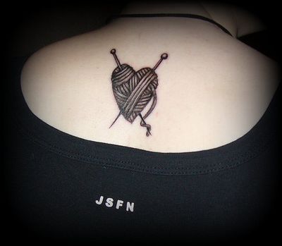 Grey Heart Yarn Tattoo On Upper Back