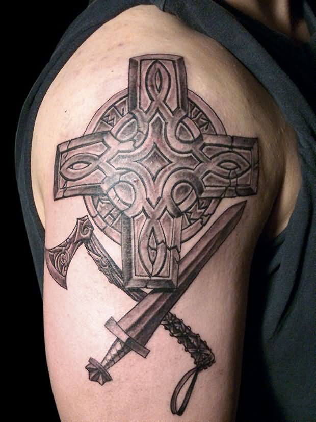 Grey Ink Cross And Weapons Tattoo On Right Shoulder