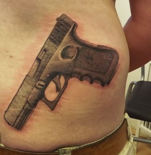 Grey Ink Gun Weapons Tattoo On Lower Back
