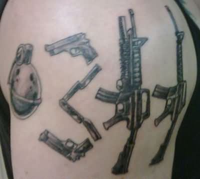 Grey Ink Military Weapons Tattoo On Left Shoulder