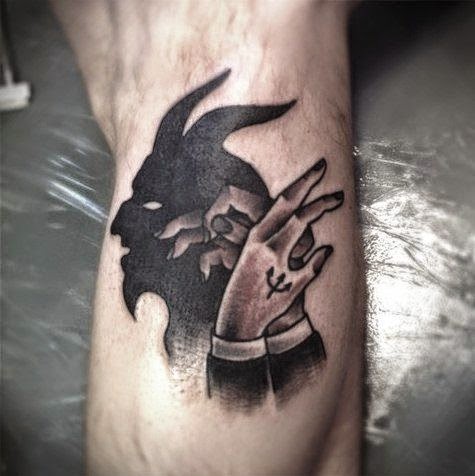 Hands Making Satan Shadow Tattoo On Arm