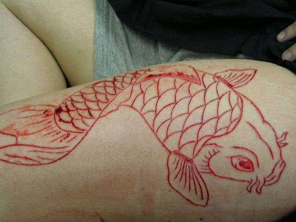 Koi Fish Scarification Tattoo On Leg