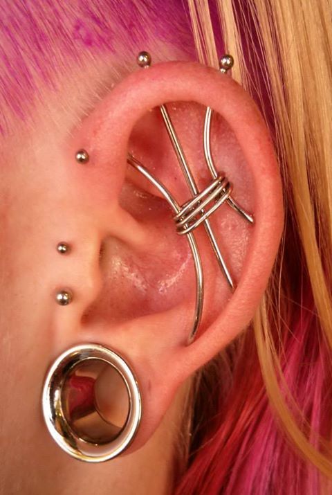 Lobe Stretching And Ear Project Piercing On Girl Left Ear