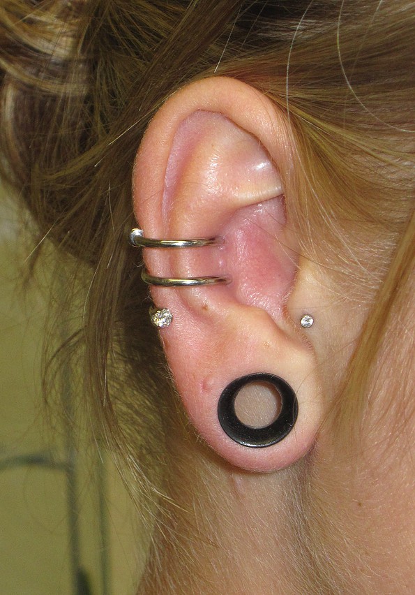 Lobe Stretching And Spiral Ear Project Piercing