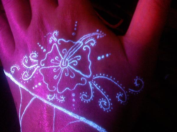 Lovely Flower Design UV Tattoo On Hand By Samantha Kingsley