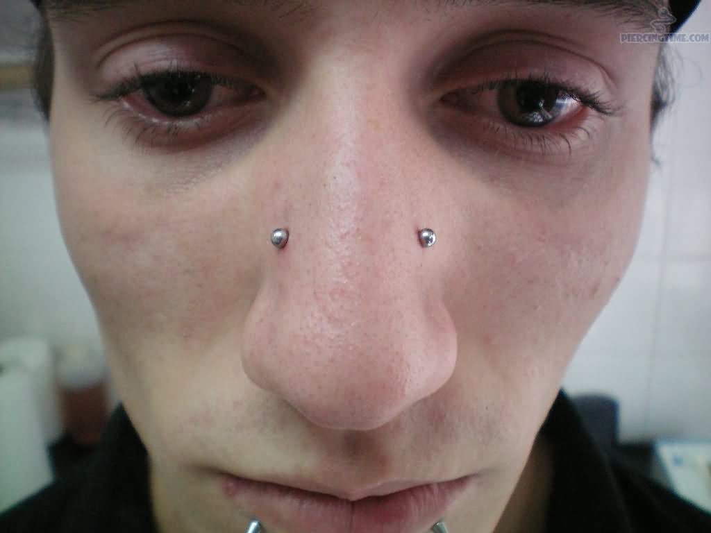 Lower Lip And High Nostril Piercing With Silver Barbell
