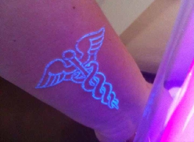 Masculine UV Symbol Tattoo On Wrist