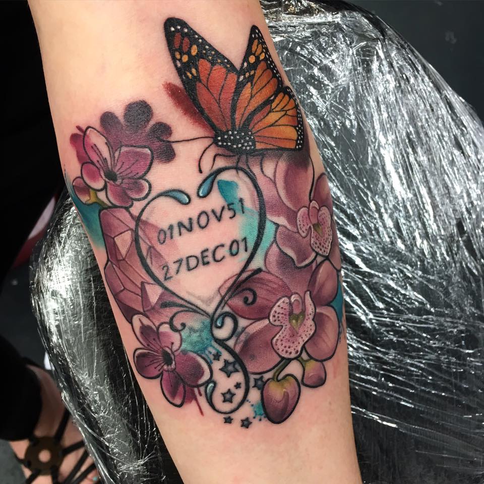Memorial Date In Heart With Flowers And Butterfly Tattoo On Arm by Makkala Rose