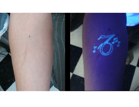 Music Notes UV Tattoo Under Daylight And Black Light Tattoo On Forearm