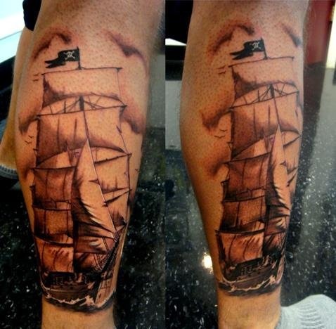 Nice Black And Grey Pirate Ship Tattoo On Back Leg