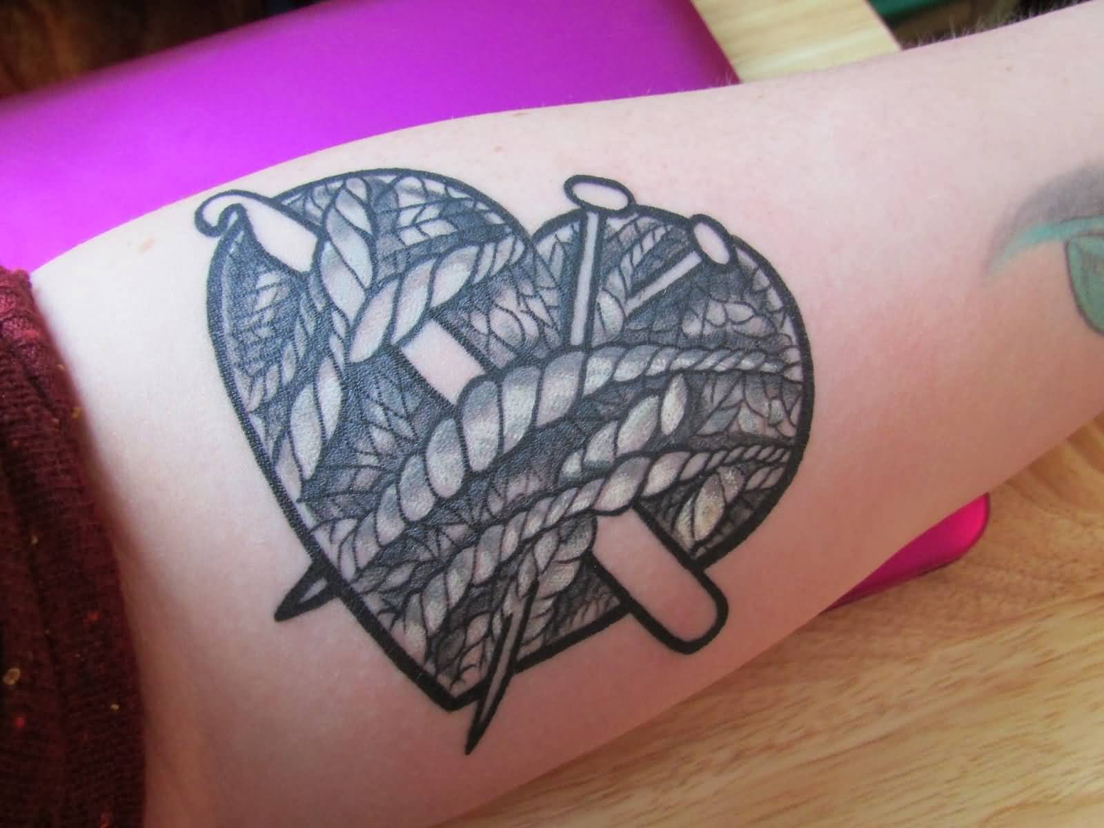 Nice Black Heart Yarn Tattoo On Forearm