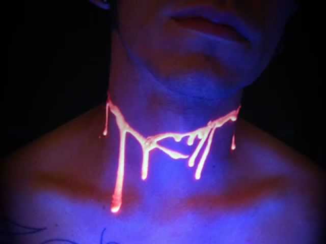 Nice Blood UV Tattoo On Neck