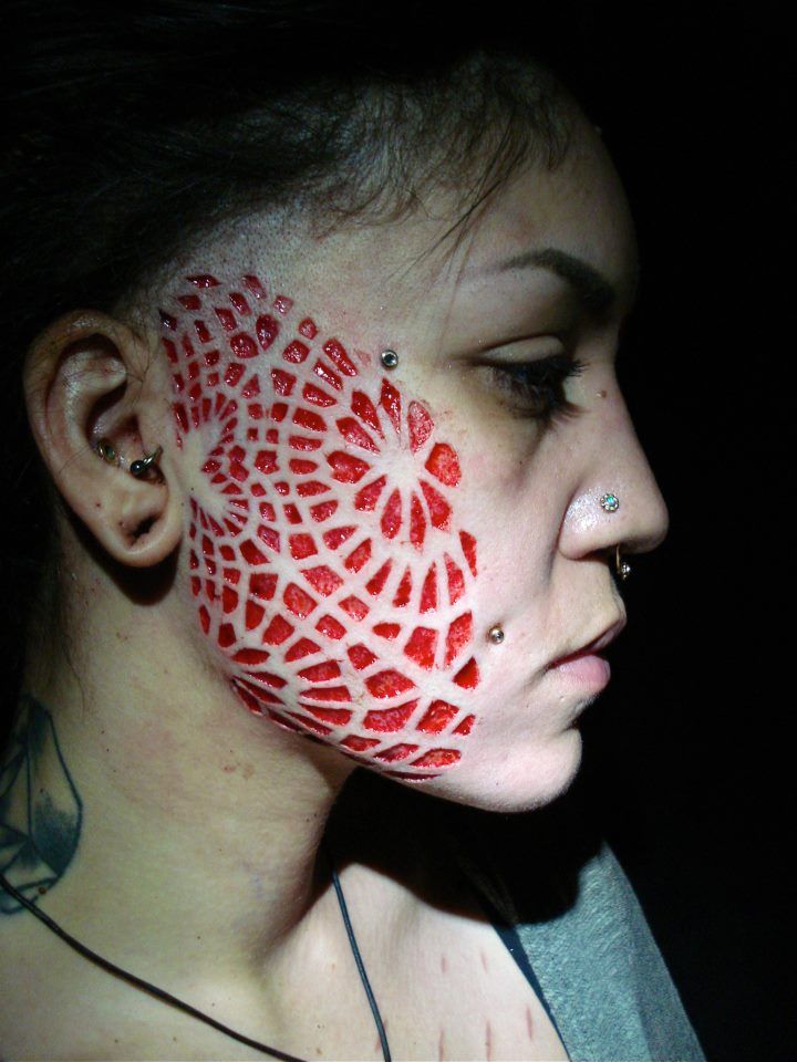 Nice Face Scarification Tattoo For Girls