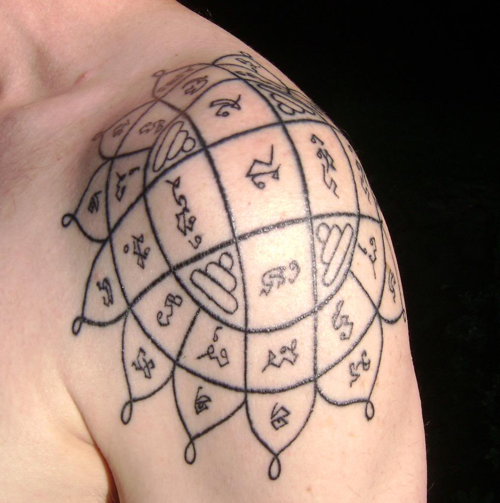 Nice Flower Spiritual Tattoo On Left Shoulder