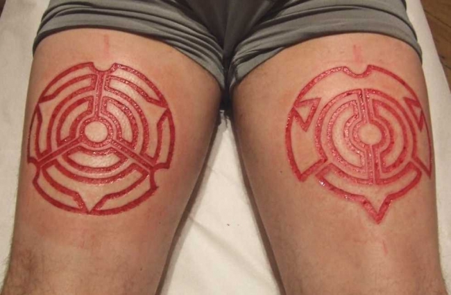 Nice Fresh Scarification Tattoos On Both Thighs