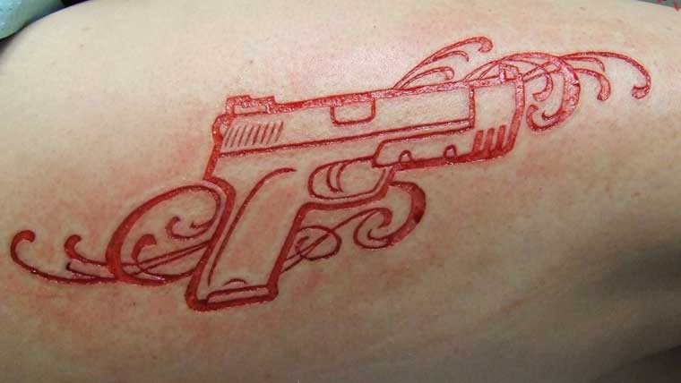 Nice Gun Scarification Tattoo