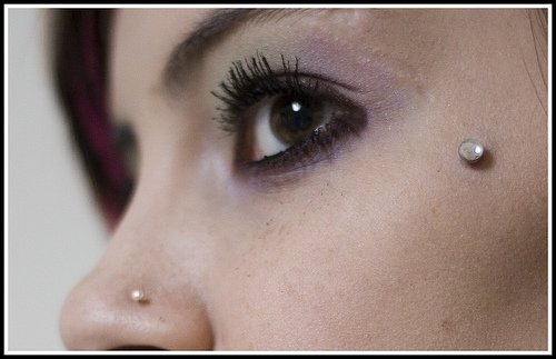 Nostril And Dermal Anchoring Piercing On Face