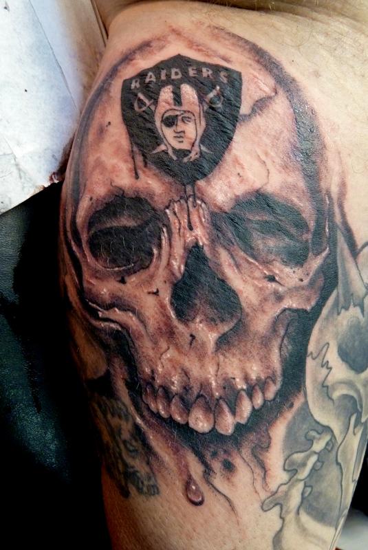 Oakland Raiders Logo On Grey Ink Skull Tattoo