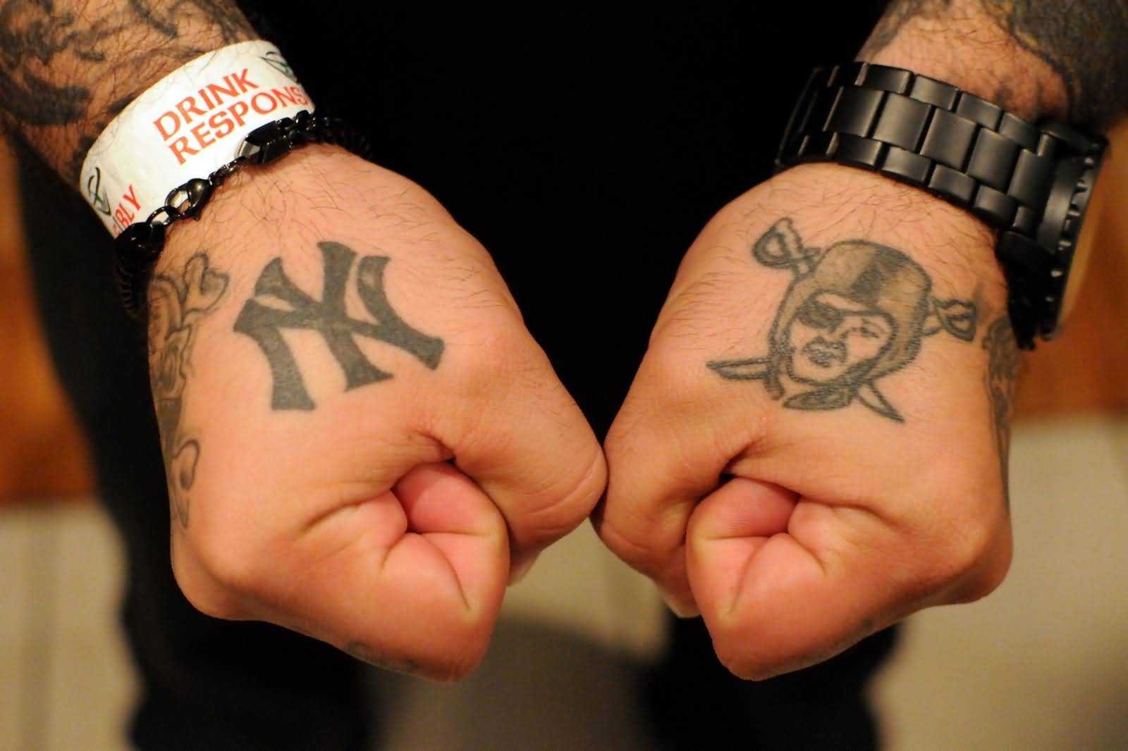 Oakland Raiders With Symbol Tattoos On Both Hands