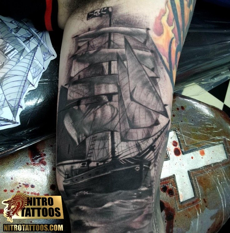 Outstanding Black Pirate Ship In Water Tattoo