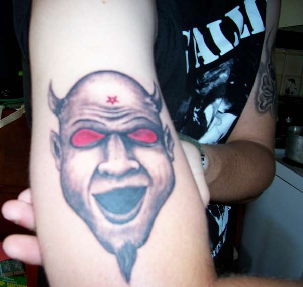 Red Eyes Satan Face Tattoo On Forearm