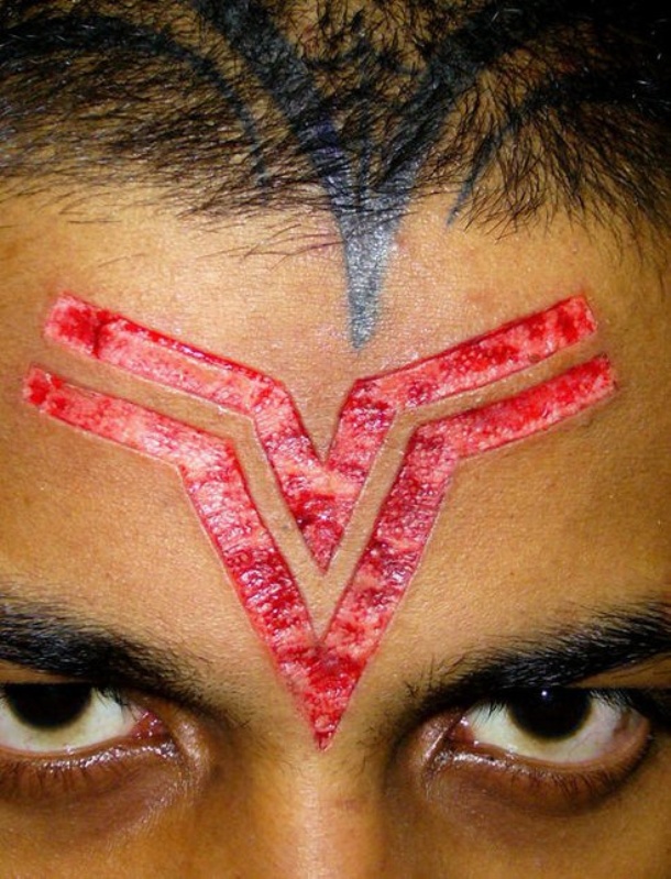 Scarification Symbol Tattoo On Forehead