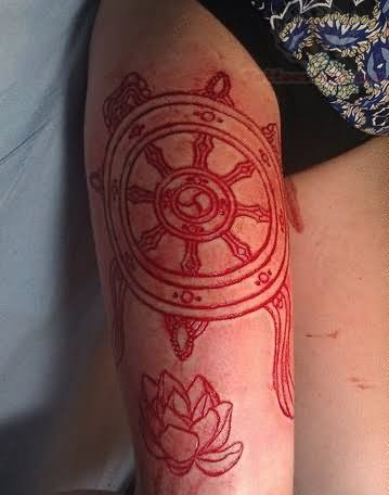 Ship Wheel And Lotus Scarification Tattoo On Thigh