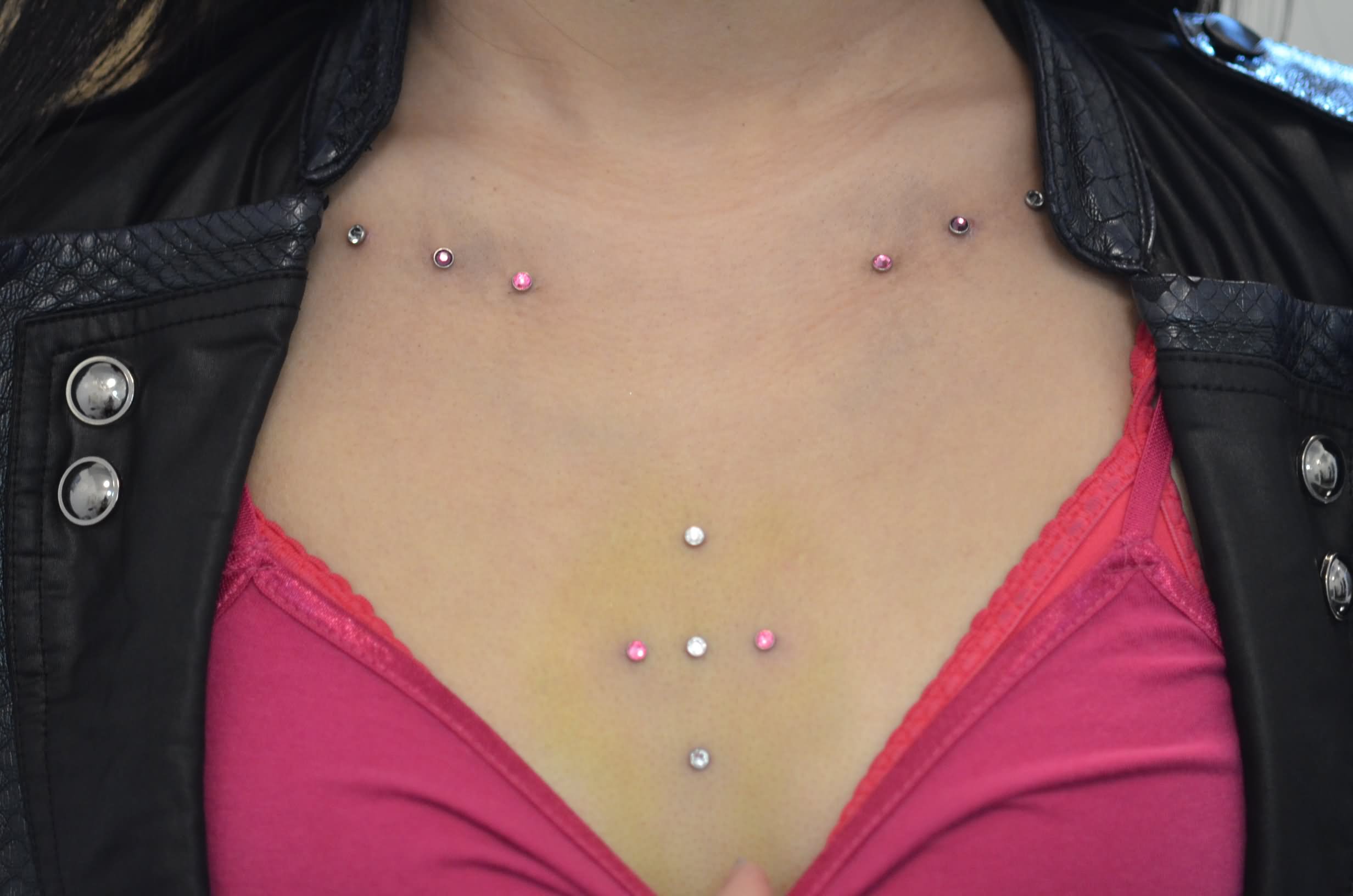 Silver And Pink Dermal Anchors Piercing On Collar Bones