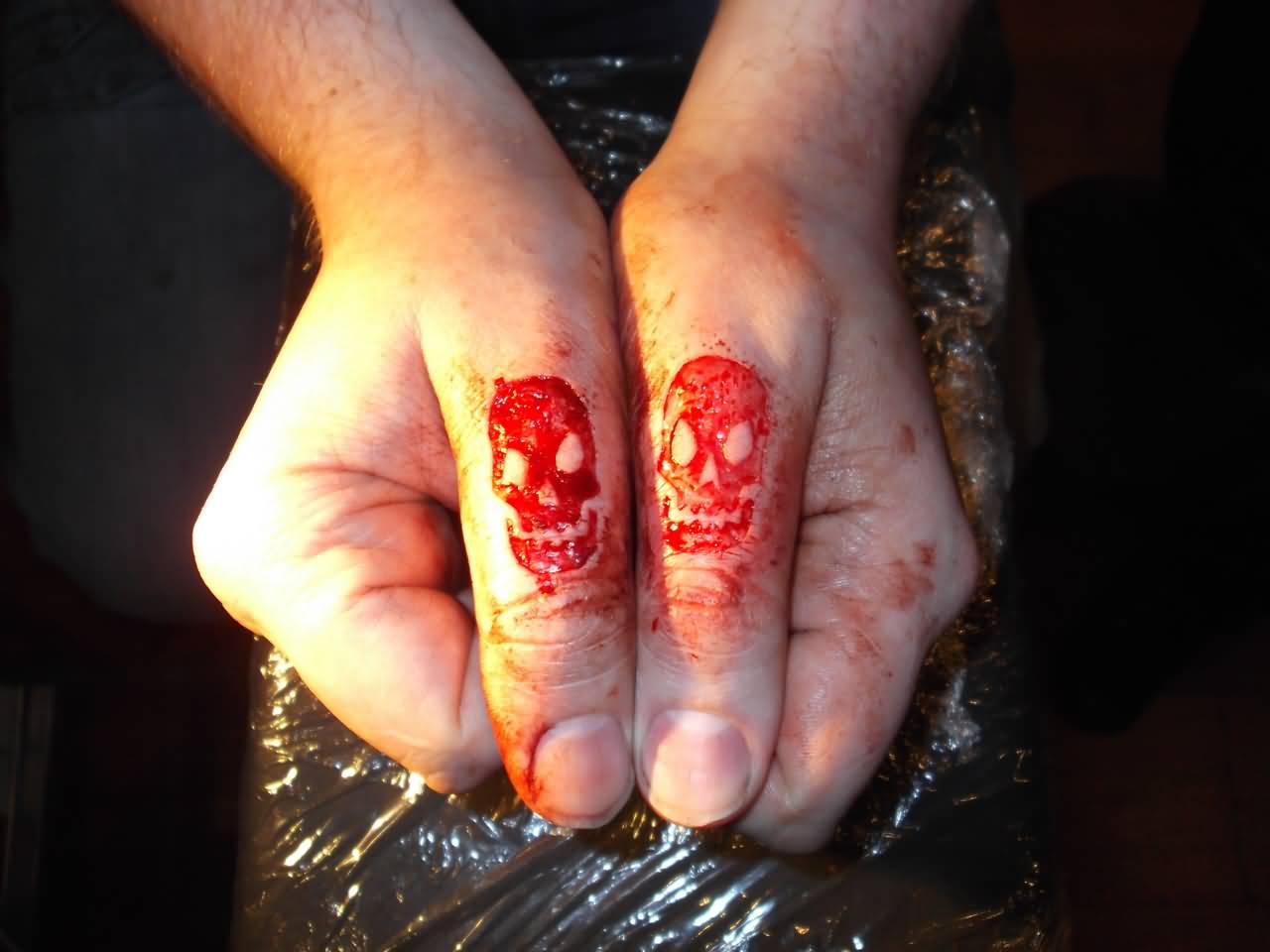 Skull Scarification Matching Tattoos On Both Thumbs By Luke Stabby Lley