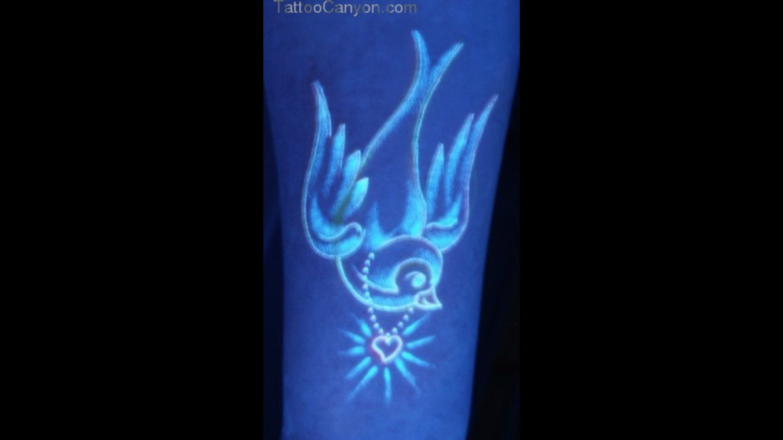 Small Bird UV Tattoo On Arm