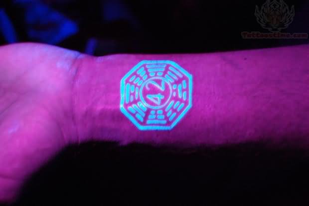 Small Logo UV Tattoo On Wrist
