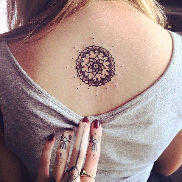 Small Round Spiritual Tattoo On Upper Back For Girls