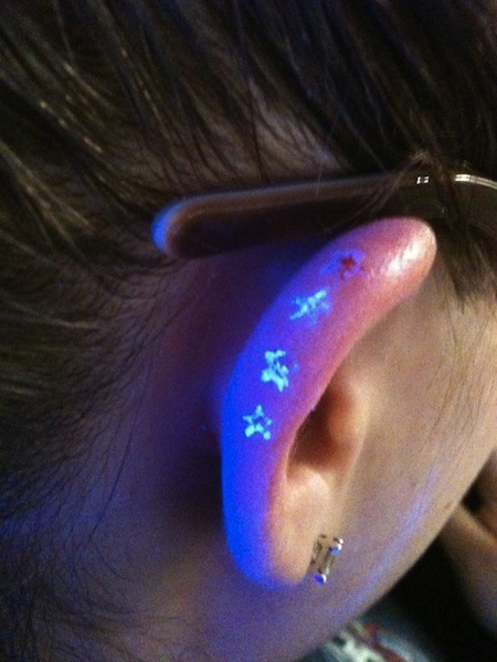 Tiny Stars UV Tattoo On Ear For Women