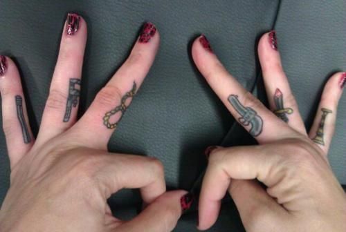 Tiny Weapons Tattoo On Fingers