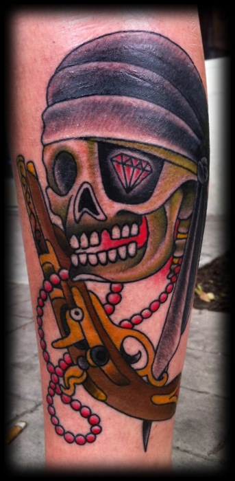 Traditional Pirate Skull And Gun Tattoo
