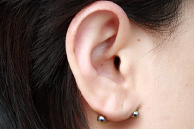 Transverse Earlobe Piercing With Silver Barbell For Girls