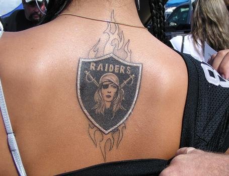Tribal Female Oakland Raiders Logo Tattoo On Upper Back