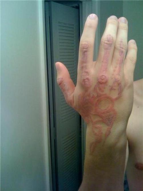 Tribal UV Healed Tattoo On Hand In Daylight